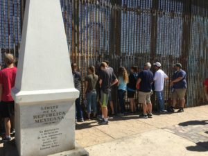 Ashley, fourth from the right in hoodie and shorts, on the Mexico side of the border.