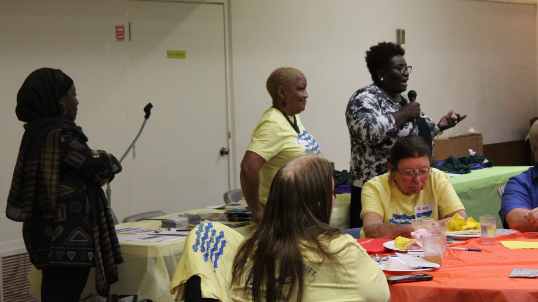 Sherri (far right) speaks about her experience as a homeowner during our community dinner in February 2020.