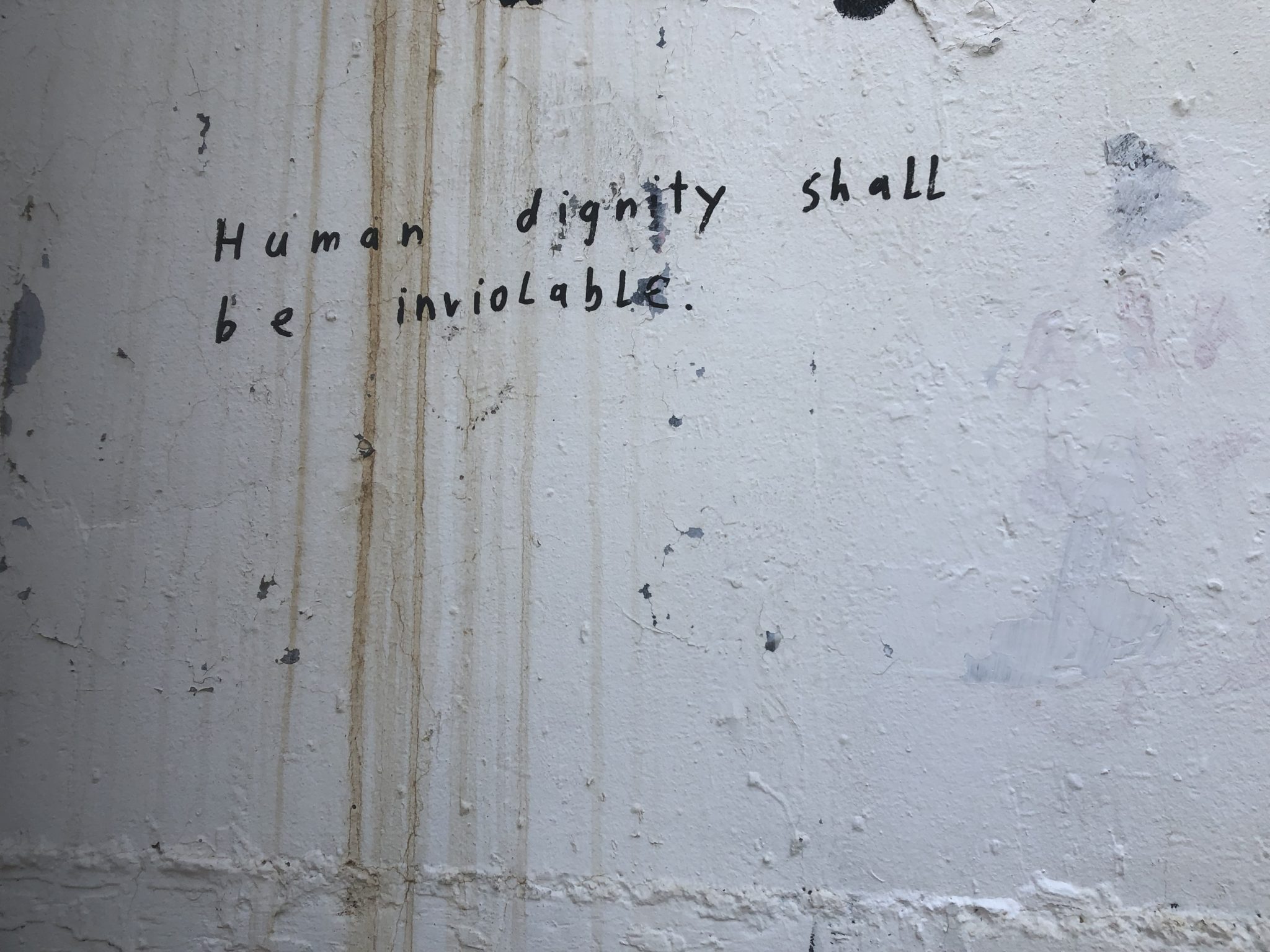 Graffiti outside Aida Refugee Camp that reads "human dignity shall be inviolable"