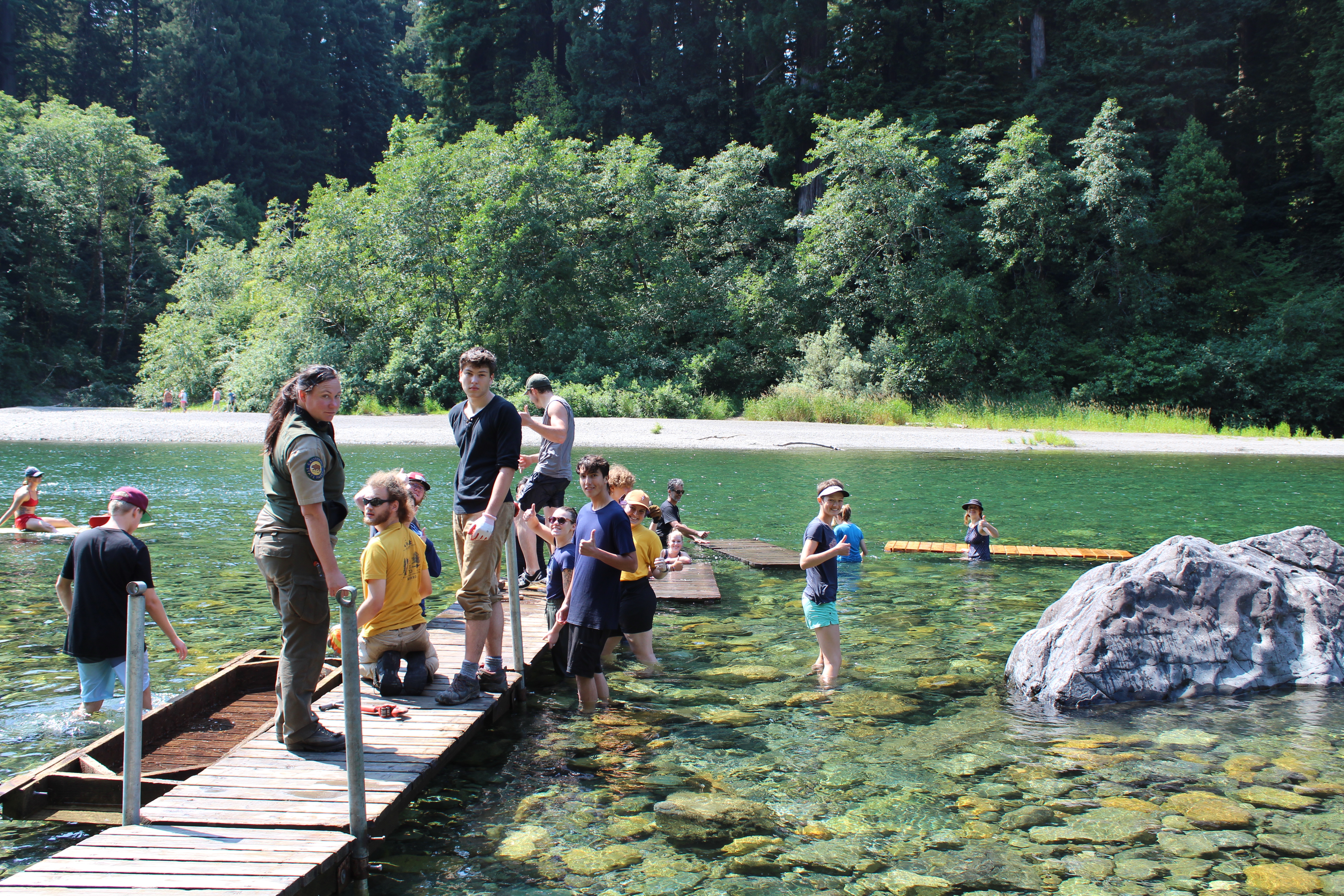 With the help of Redwood National & State Parks, SSP volunteers install a seasonal foot bridge across the Smith River.